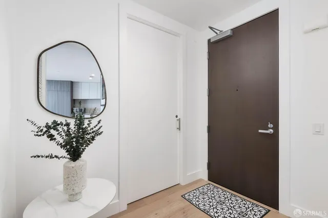 a picture of a room with a mirror and a potted plant