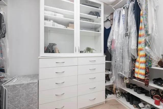 a view of walk in closet with clothes