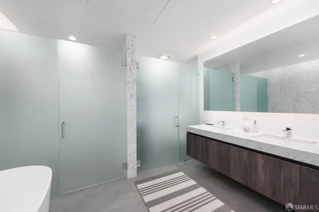 a bathroom with a double vanity sink mirror and toilet