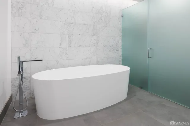 a white bath tub sitting in a bathroom