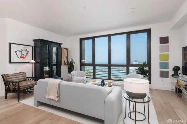 a living room with furniture and large windows