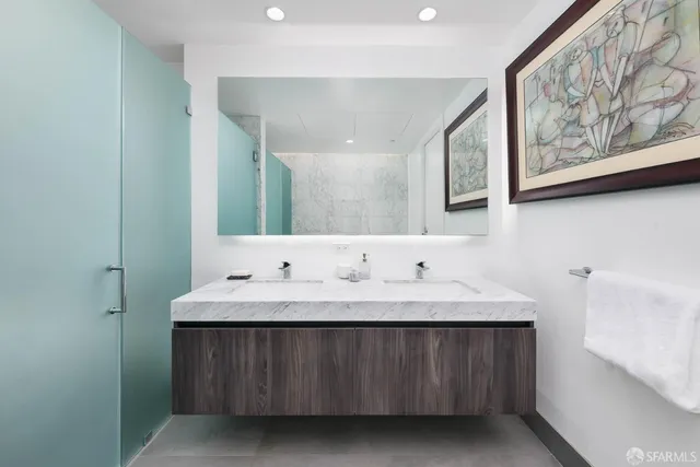 a bathroom with a double vanity sink and a mirror