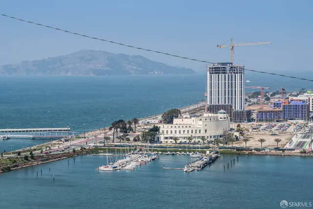 a living room with furniture and floor to ceiling windows
