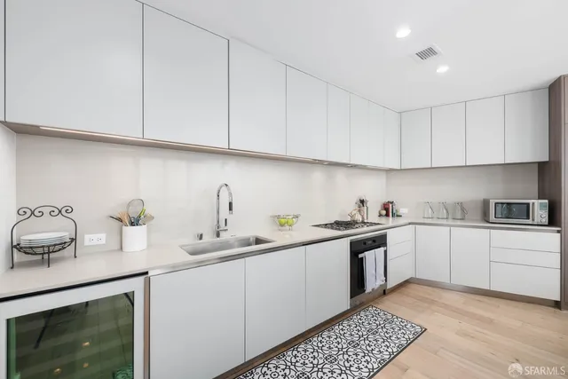 a kitchen with stainless steel appliances granite countertop a sink stove and cabinets