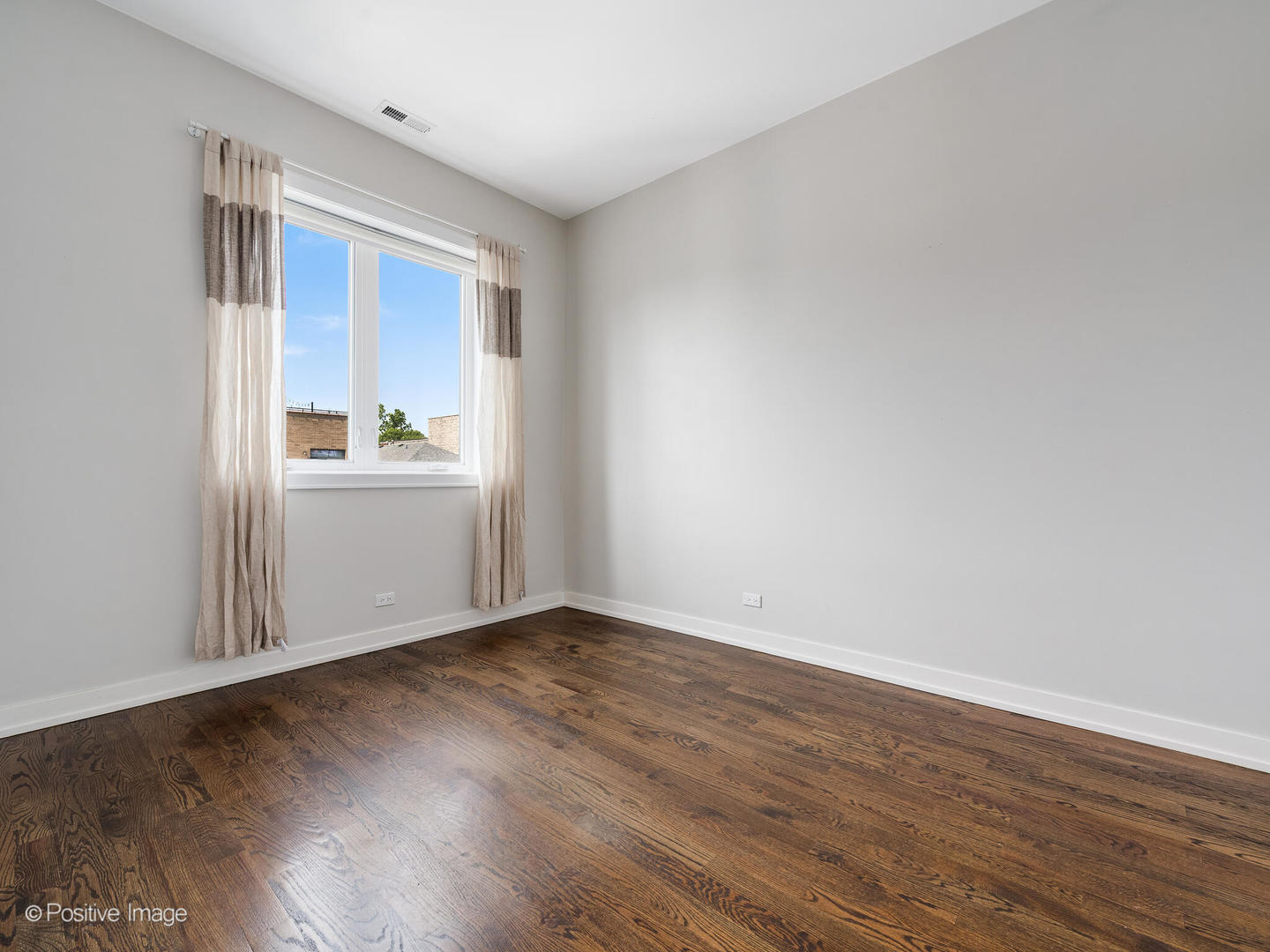 1832 West Rice Street, Unit 3 Chicago, IL 60622 - Photo 23 of 30 a view of an empty room with wooden floor and a window
