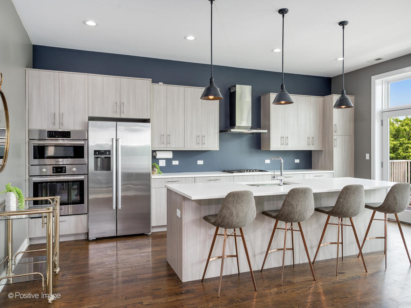 1832 West Rice Street, Unit 3 Chicago, IL 60622 - Photo 6 of 30 a kitchen with stainless steel appliances kitchen island granite countertop a refrigerator a stove a sink with a dining table and chairs