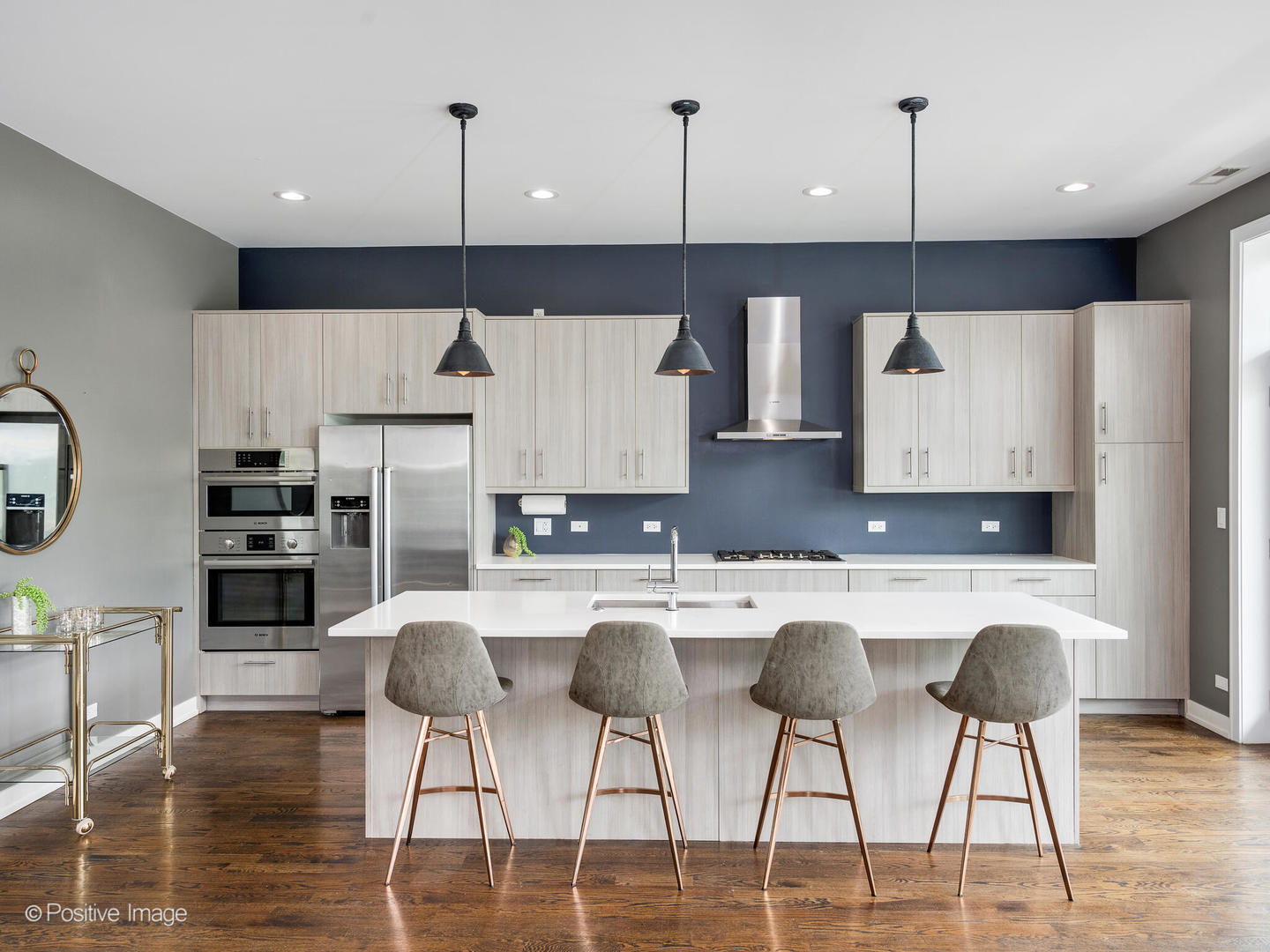 1832 West Rice Street, Unit 3 Chicago, IL 60622 - Photo 7 of 30 a kitchen with stainless steel appliances granite countertop a stove a refrigerator a sink a dining table and chairs with wooden floor