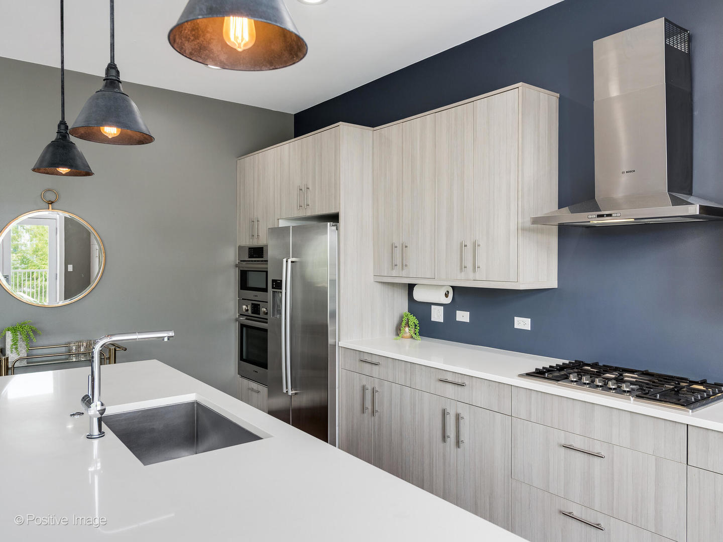 1832 West Rice Street, Unit 3 Chicago, IL 60622 - Photo 9 of 30 a kitchen with kitchen island granite countertop a sink a stove and refrigerator