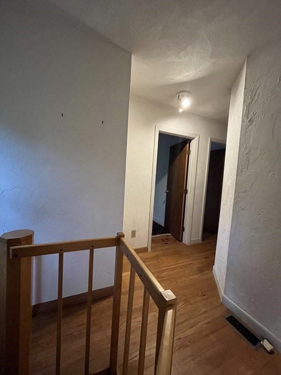6 New Street Billerica, MA 01821 - Photo 15 of 17 a view of a hallway and a livingroom with wooden floor