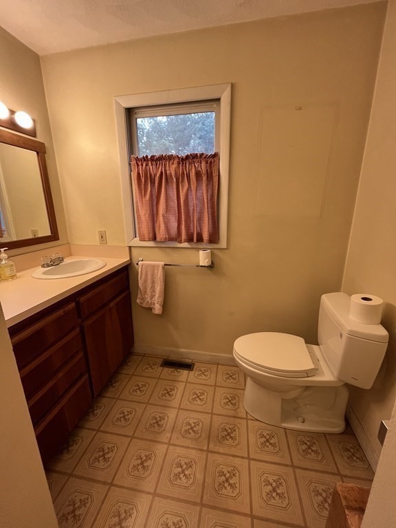 6 New Street Billerica, MA 01821 - Photo 16 of 17 a bathroom with a toilet sink and mirror