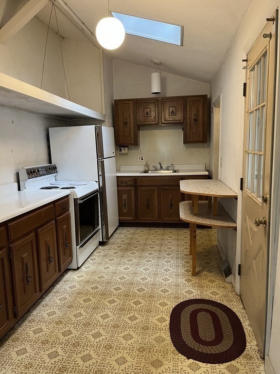 6 New Street Billerica, MA 01821 - Photo 9 of 17 a kitchen with stainless steel appliances granite countertop a sink stove and cabinets