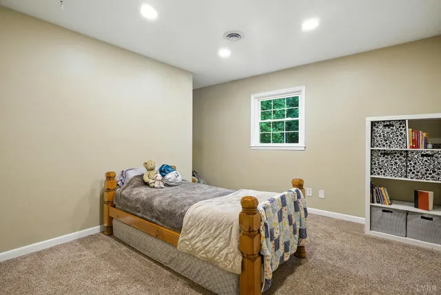 a bedroom with a bed and a table in it