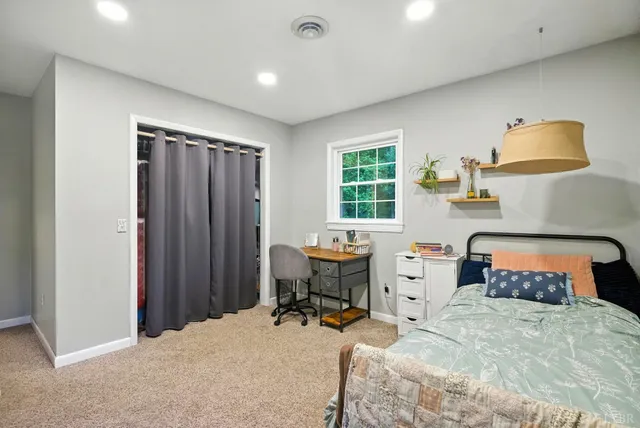 a bedroom with a bed and a table