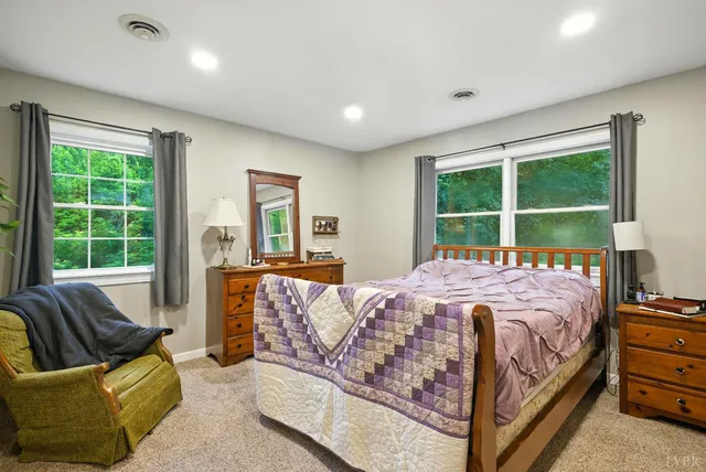 a bedroom with a bed and glass window