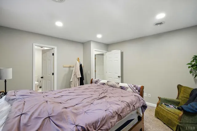 a bedroom with a bed and a couch