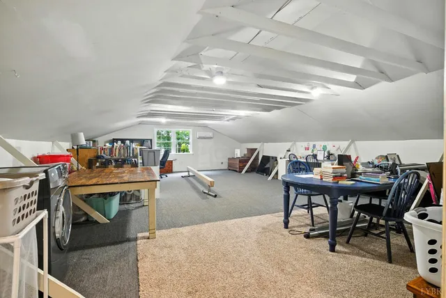 a view of a dining room with furniture and a chandelier