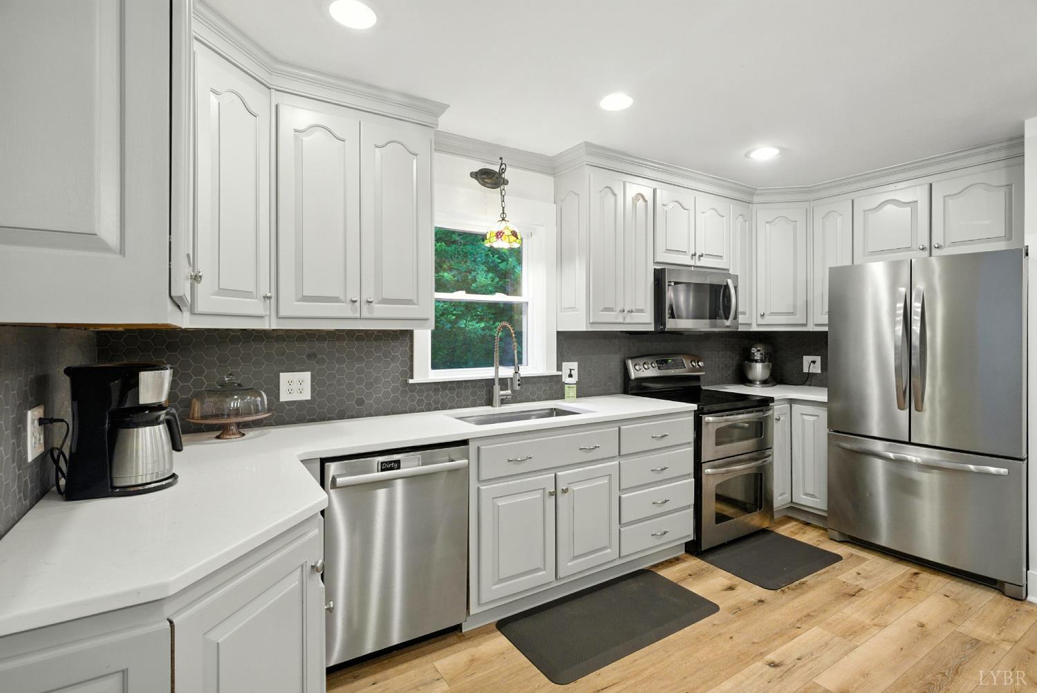 2078 Featherfin Road Prospect, VA 23960 - Photo 4 of 49 a kitchen with white cabinets stainless steel appliances and a window