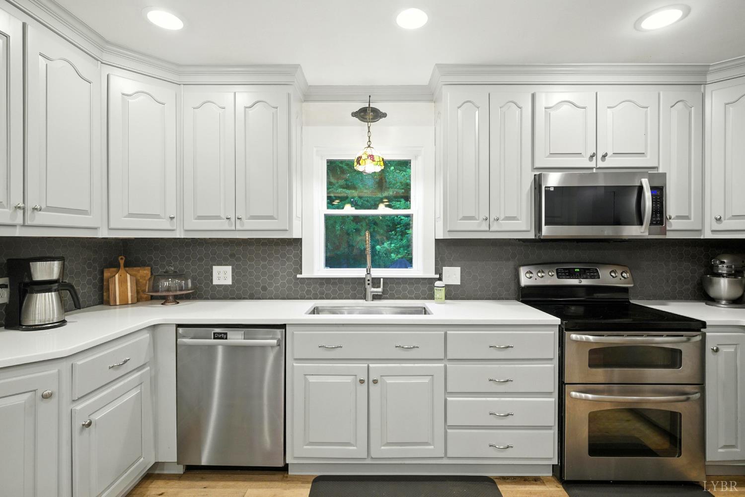 2078 Featherfin Road Prospect, VA 23960 - Photo 6 of 49 a kitchen with white cabinets and appliances