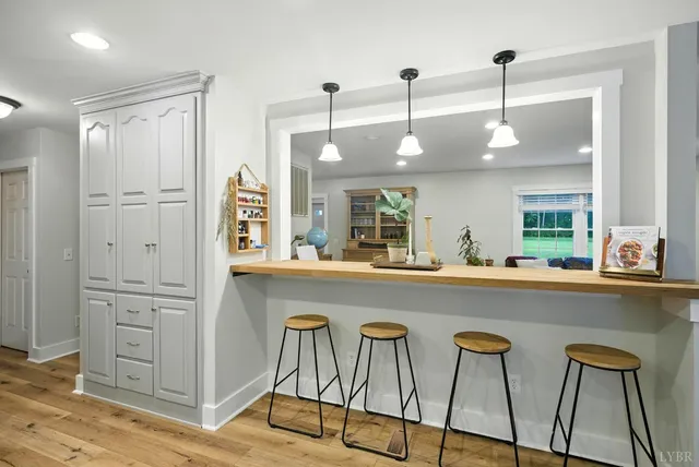 a kitchen with cabinets and chandelier