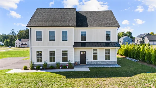 a front view of a house with a yard