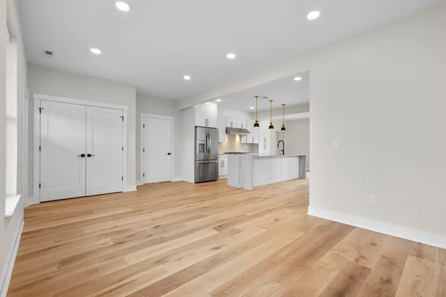 a view of a kitchen with refrigerator and window