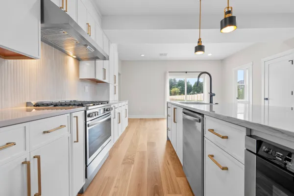 a kitchen with granite countertop a stove and a sink