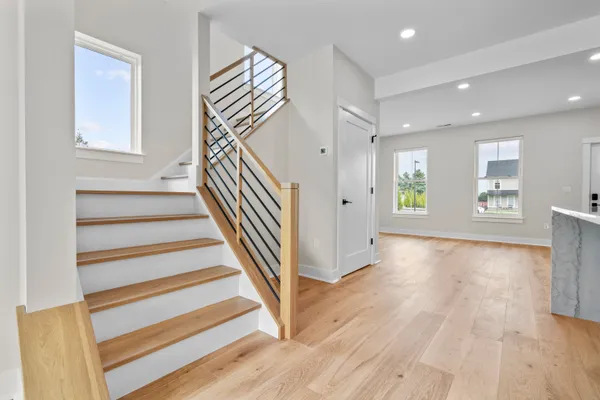a view of entryway and hall with wooden floor