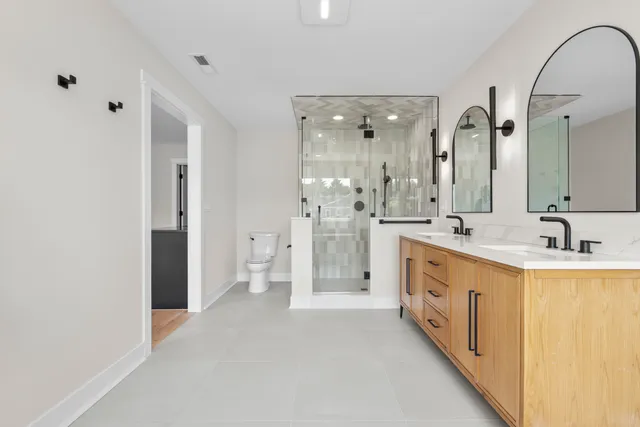 a spacious bathroom with a double vanity sink mirror and double