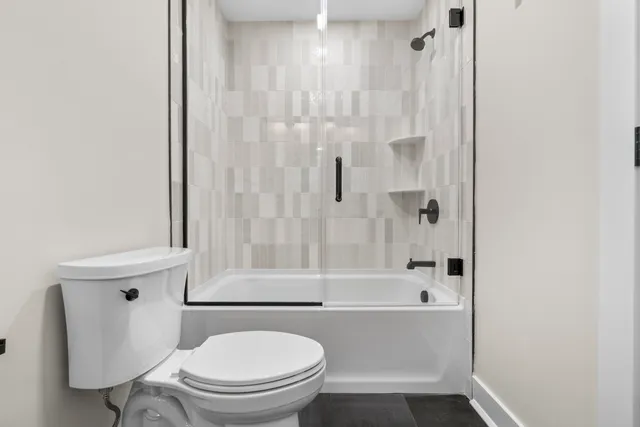 a bathroom with a toilet and a bathtub