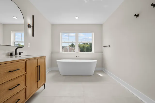 a spacious bathroom with a bathtub and sink