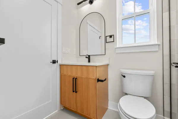 a bathroom with a toilet a sink and a window