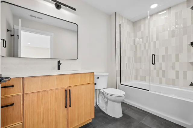 a bathroom with a toilet sink and a mirror