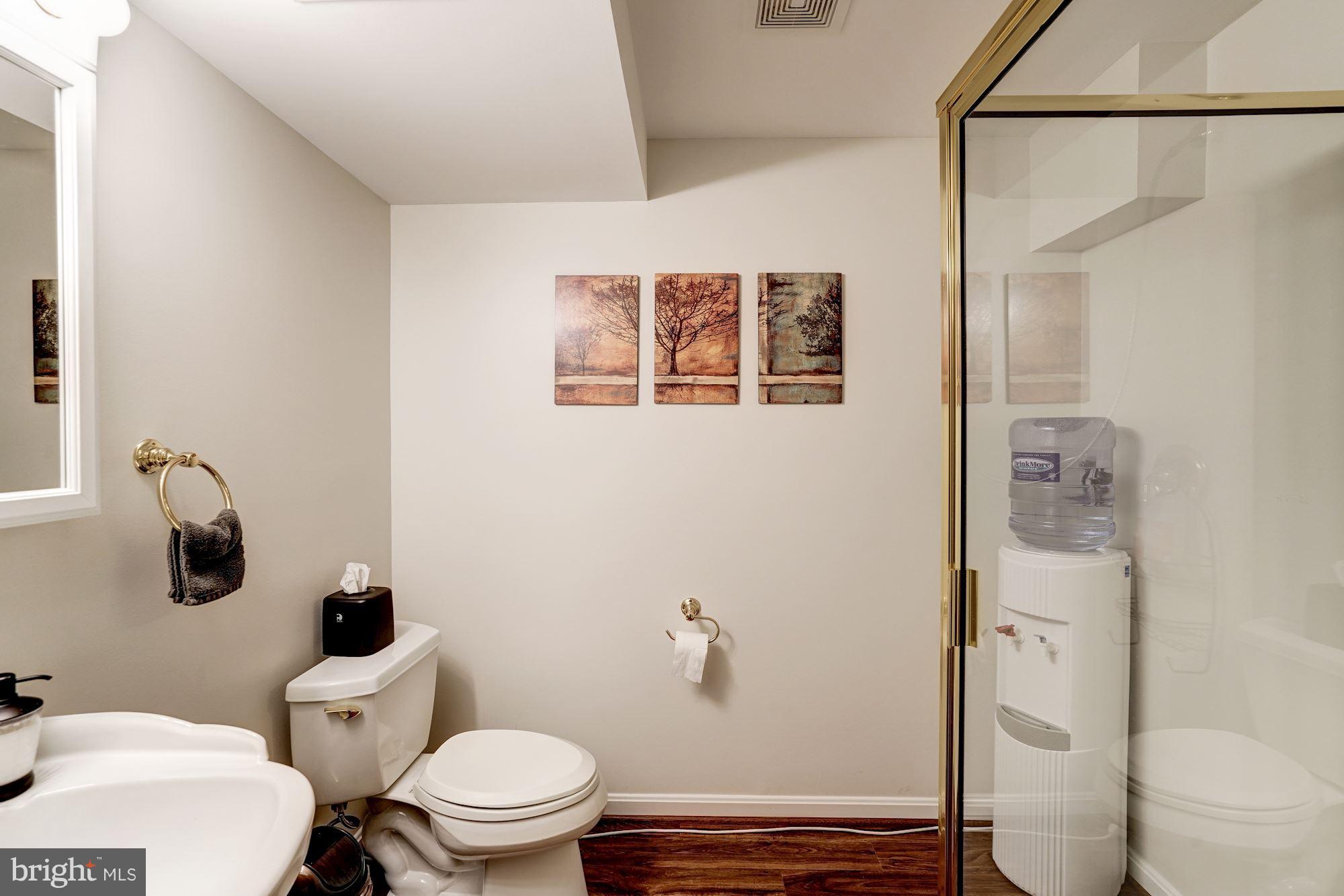 2104 Salt Kettle Way Reston, VA 20191 - Photo 23 of 29 a white toilet sitting next to a bathroom sink and a mirror