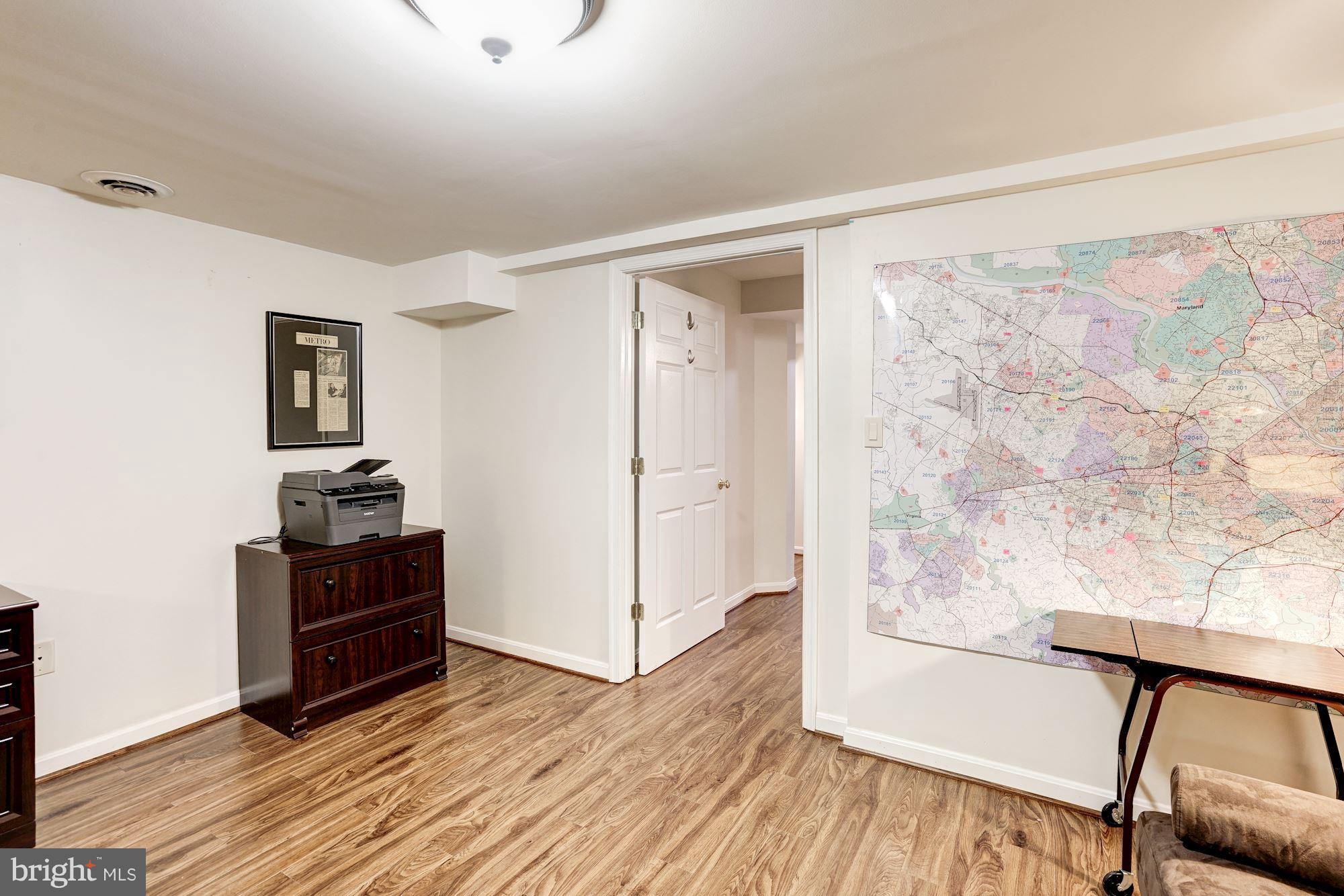 2104 Salt Kettle Way Reston, VA 20191 - Photo 25 of 29 a view of a hallway with wooden floor and furniture
