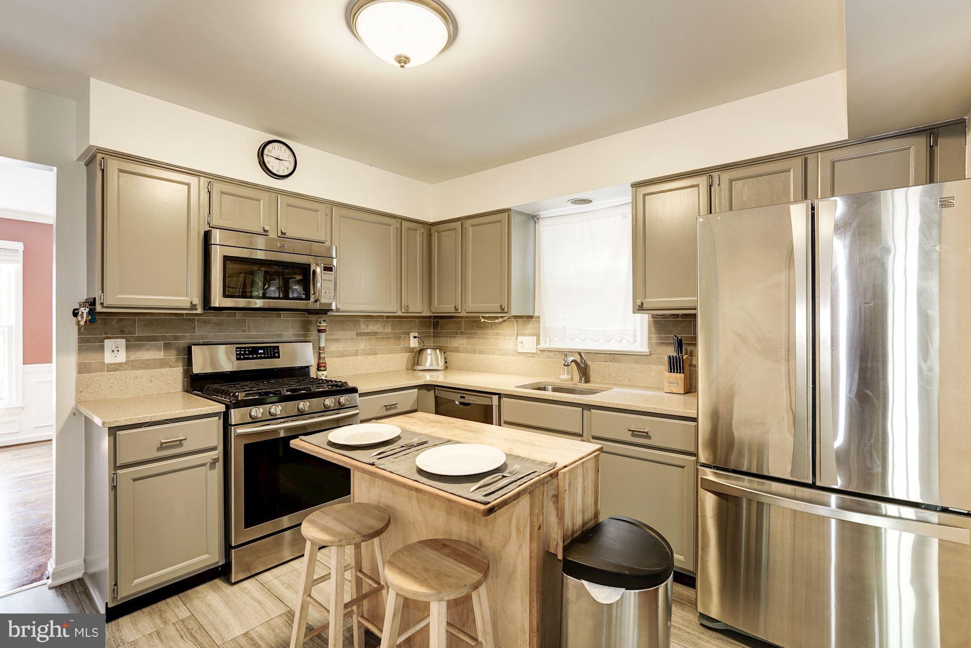 2104 Salt Kettle Way Reston, VA 20191 - Photo 7 of 29 a kitchen with a stove a sink and a refrigerator
