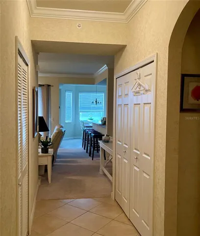 a view of a hallway with dining area and glass door