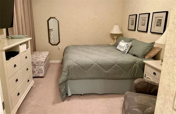 a bedroom with a bed and ceiling fan