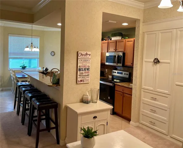 a kitchen with refrigerator and mirror