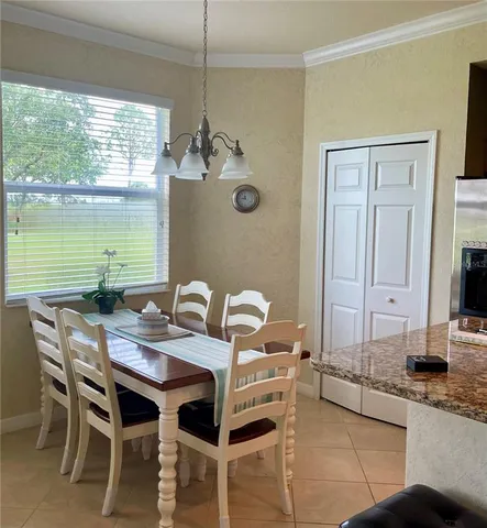 a dining room with furniture and window