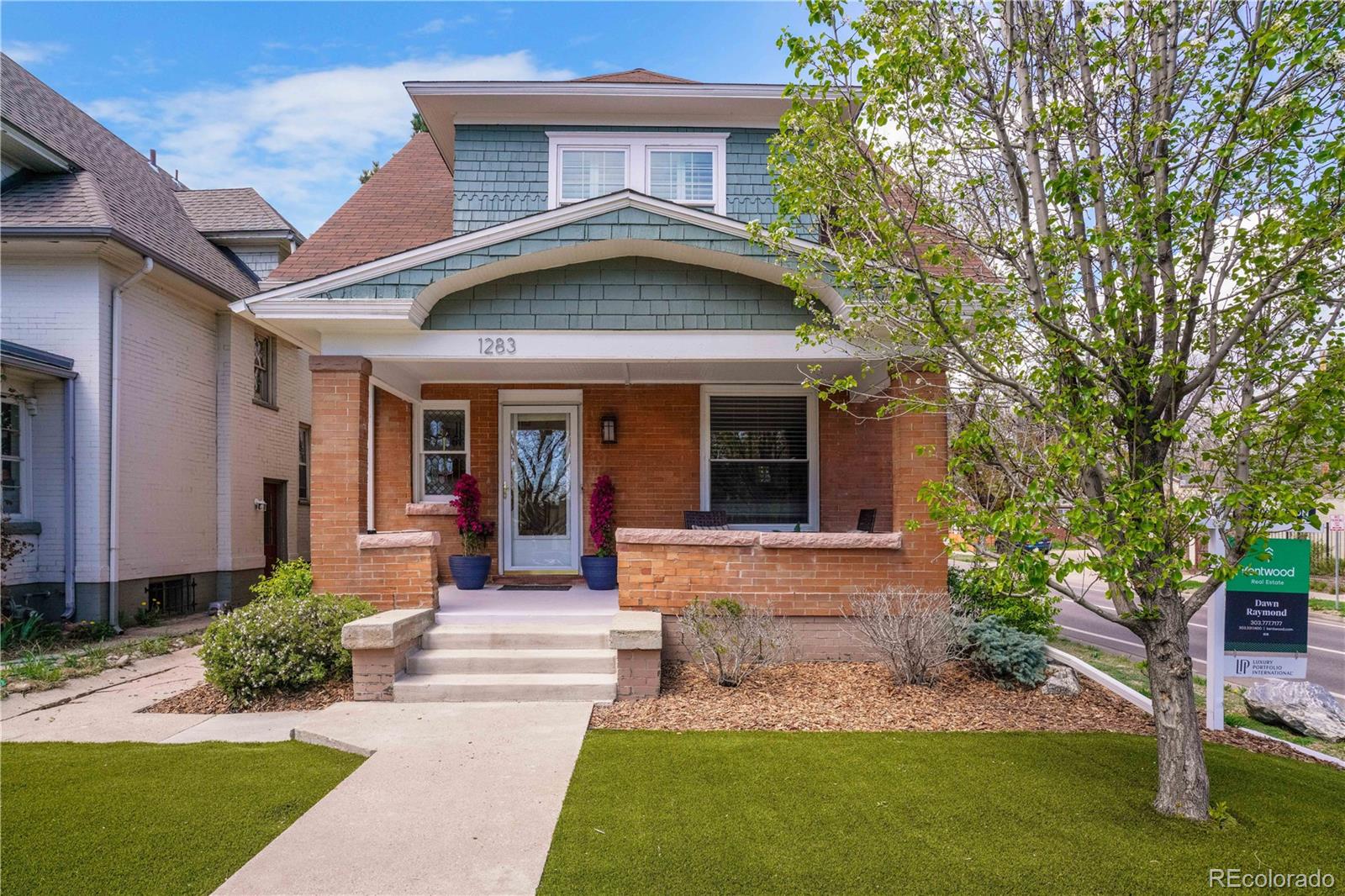 1283 Madison Street Denver, CO 80206 - Photo 1 of 34 a front view of a house with a yard