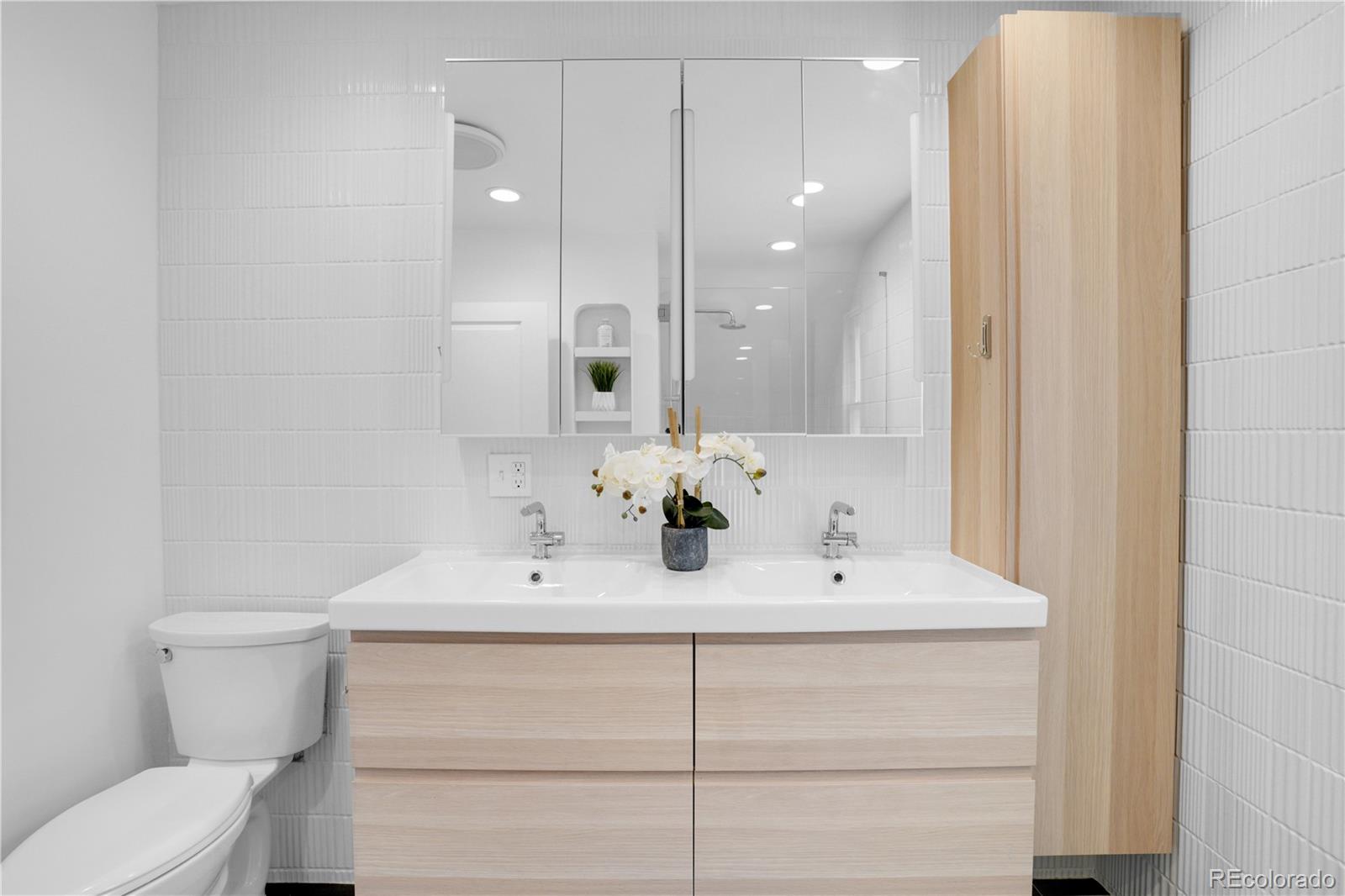 1283 Madison Street Denver, CO 80206 - Photo 19 of 34 a bathroom with a sink vanity mirror and toilet