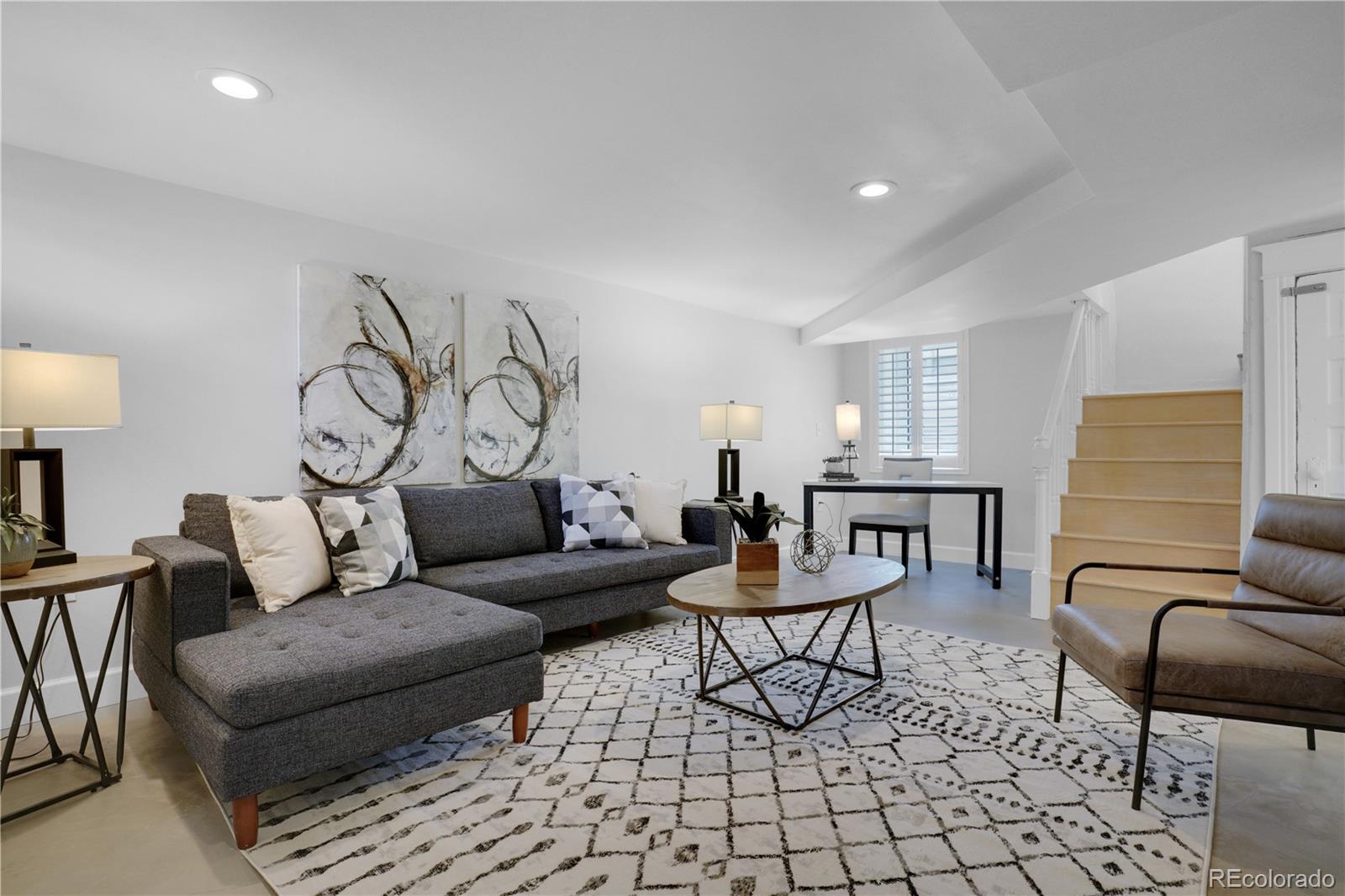 1283 Madison Street Denver, CO 80206 - Photo 23 of 34 a living room with furniture and a table