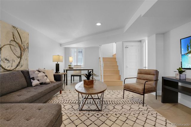 a living room with furniture and a potted plant