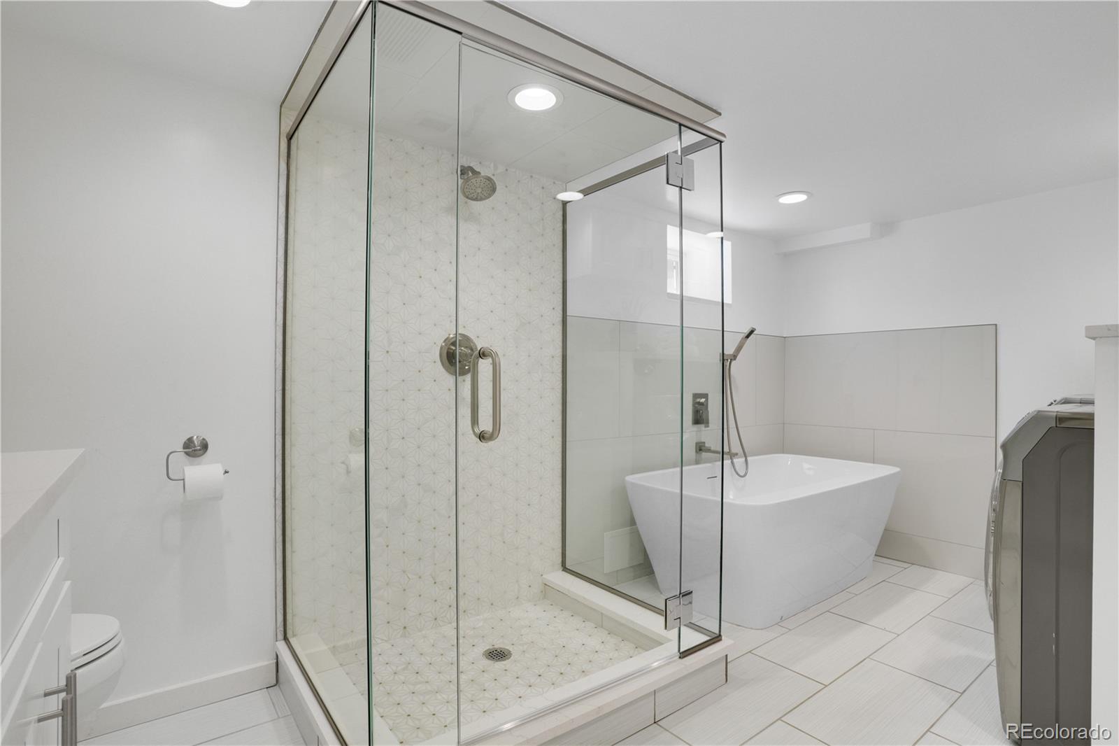 1283 Madison Street Denver, CO 80206 - Photo 26 of 34 a bathroom with a shower and a sink