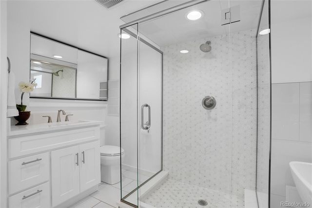 a bathroom with a shower sink vanity and mirror
