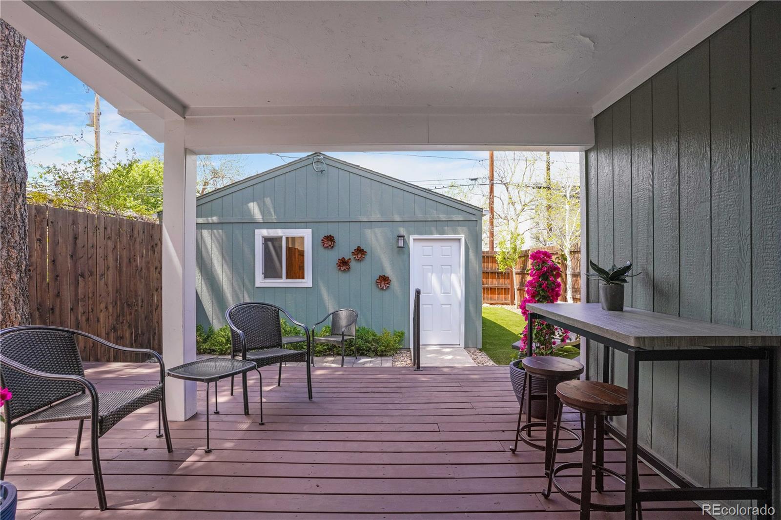 1283 Madison Street Denver, CO 80206 - Photo 28 of 34 a view of a house with backyard wooden deck and furniture