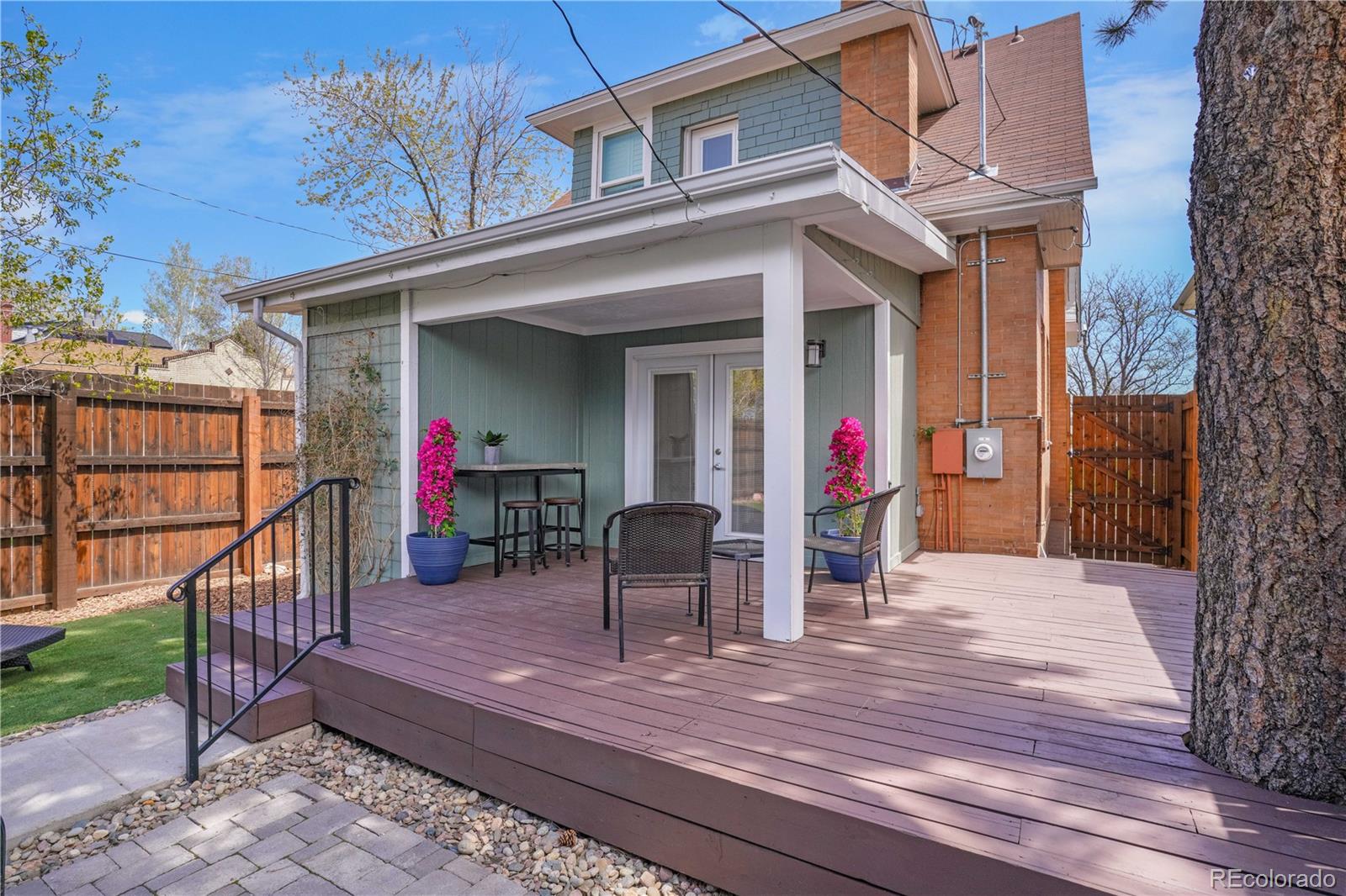 1283 Madison Street Denver, CO 80206 - Photo 30 of 34 a view of a house with wooden deck and furniture