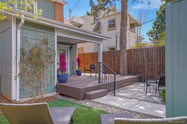 a view of a patio with table and chairs