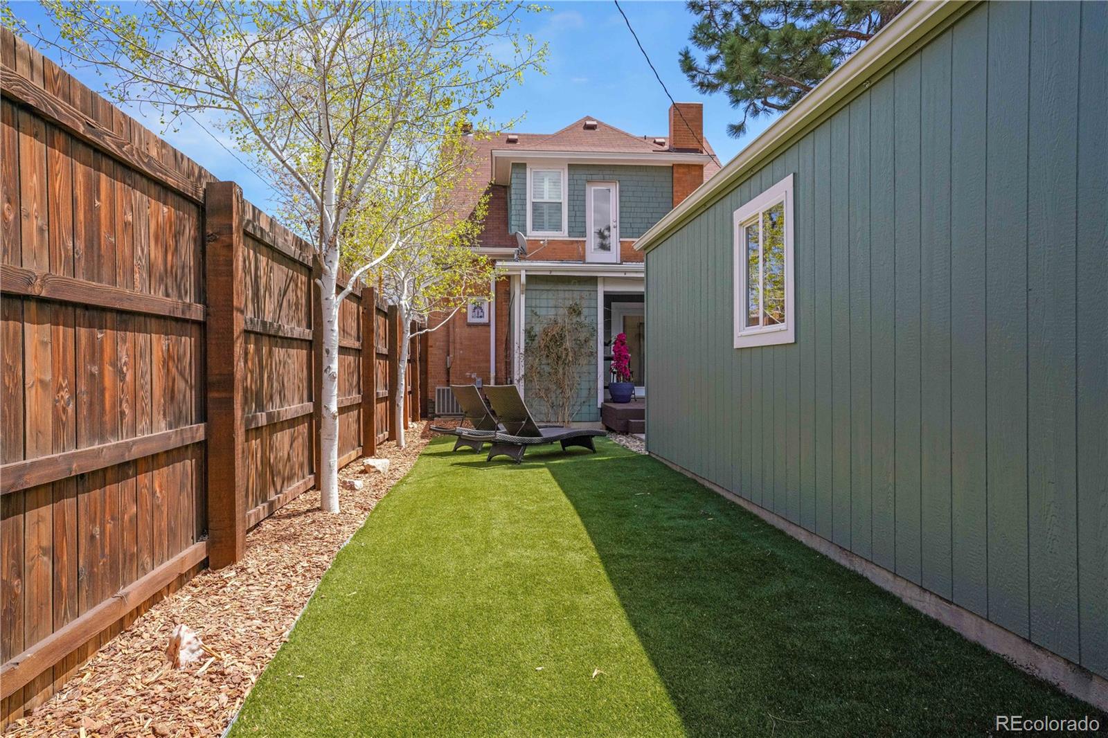 1283 Madison Street Denver, CO 80206 - Photo 33 of 34 a view of an house with backyard and a garden