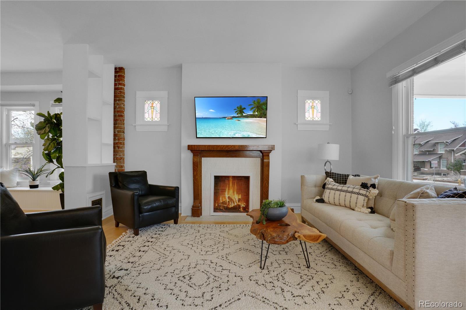 1283 Madison Street Denver, CO 80206 - Photo 6 of 34 a living room with furniture and a fireplace